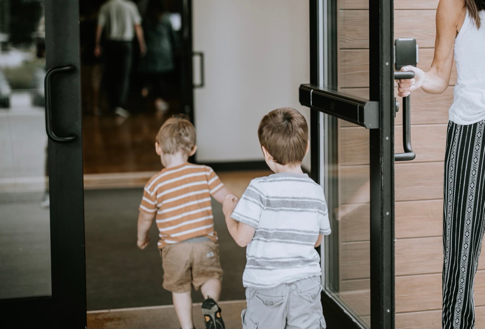 Two young boys walking through the church doors on a Sunday morning.