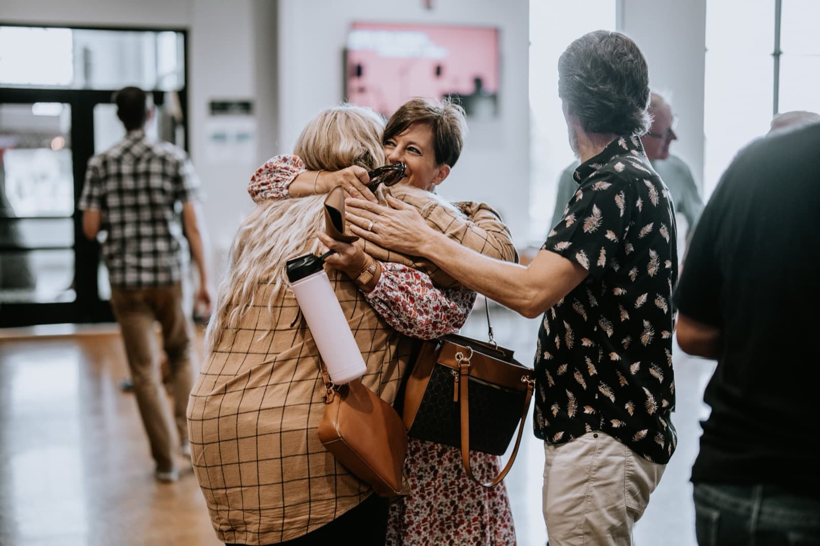 Women sharing a warm embrace in the lobby at Pleasant Valley Church.