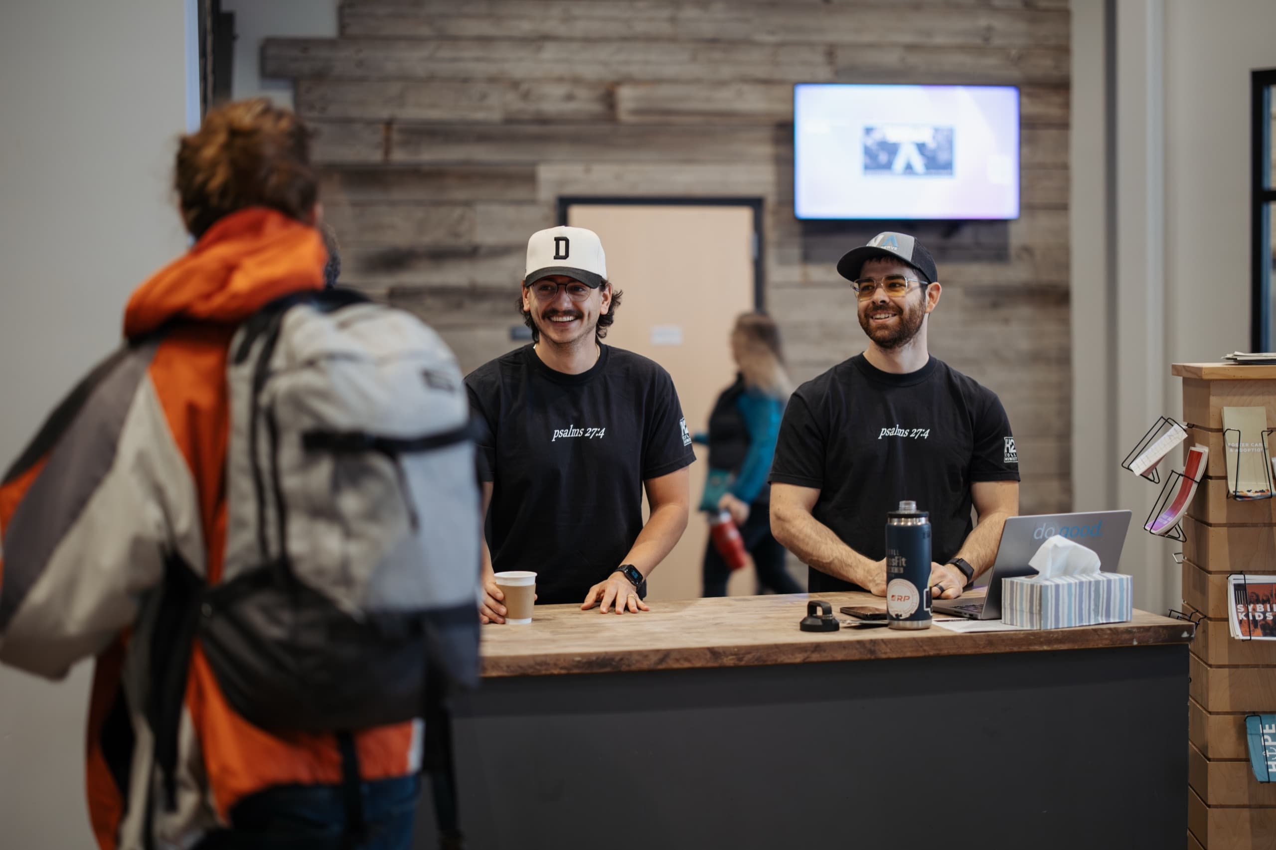 Friendly volunteers greeting visitors at the welcome desk.